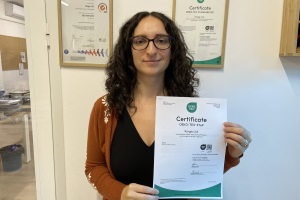 Kristi White Sustainability Manager holding Kinglys latest OEKO TEX STeP certificate - Kingly: Oeko-Tex-Zertifikat